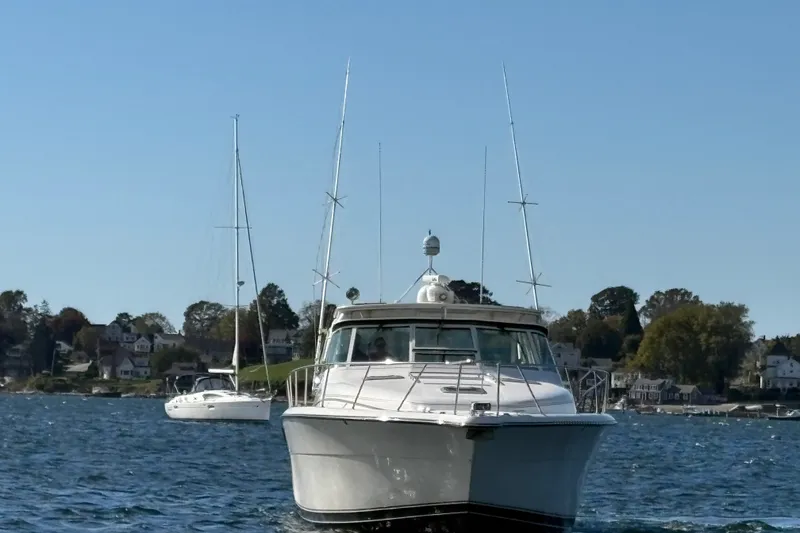 Slide: The Image of 1996 Tiara Yachts 4300 Open cruising on a scenic waterfront. - 8