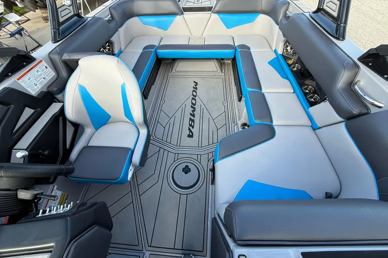 Slide: The Image of 2022 Moomba Kaiyen boat interior with blue and gray seating, modern design. - 11