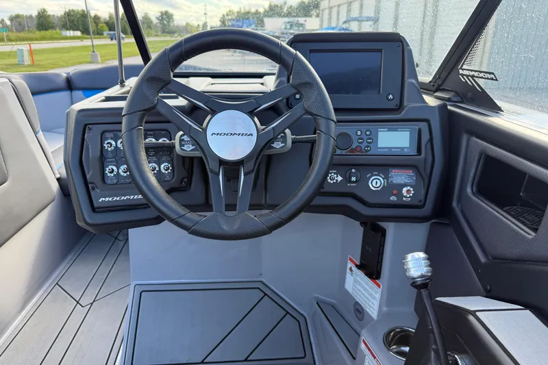 Slide: The Image of 2022 Moomba Kaiyen boat dashboard with steering wheel and control panel. - 13
