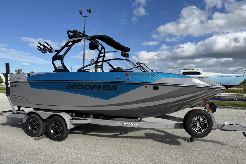 Slide: The Image of 2022 Moomba Kaiyen boat on trailer under a partly cloudy sky. - 16