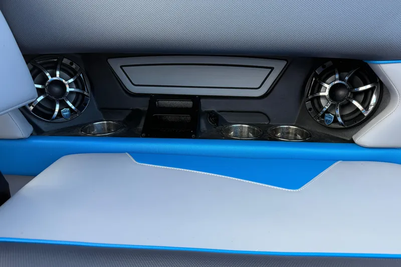 Slide: The Image of 2022 Moomba Kaiyen interior with speakers and cup holders, featuring blue and gray upholstery. - 21