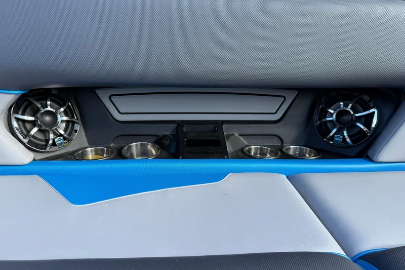 Slide: The Image of 2022 Moomba Kaiyen interior with speakers and cup holders, featuring blue and gray accents. - 22