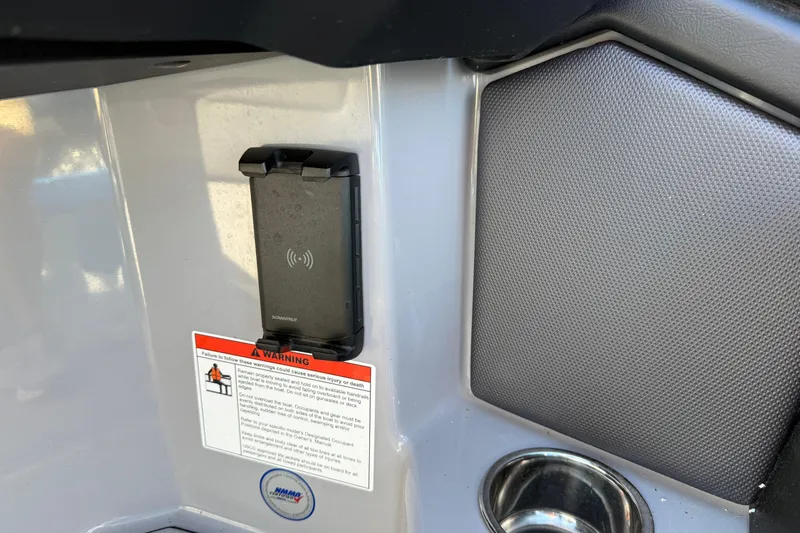 Slide: The Image of 2022 Moomba Kaiyen interior with phone holder and warning label. - 28