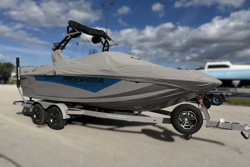 Slide: The Image of 2022 Moomba Kaiyen boat covered on trailer under cloudy sky. - 5