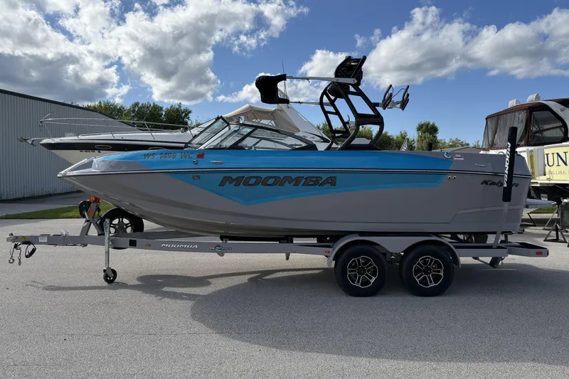 Slide: The Image of 2022 Moomba Kaiyen boat on trailer under cloudy sky. - 6