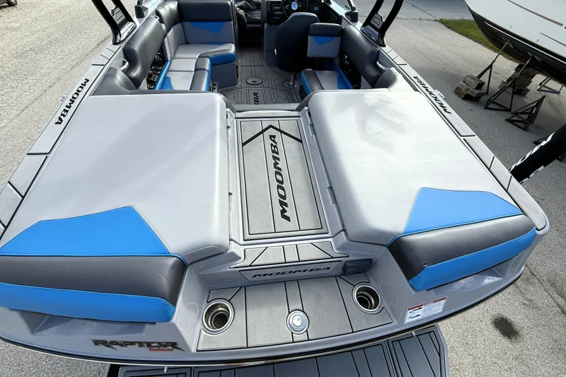 Slide: The Image of 2022 Moomba Kaiyen boat interior with gray and blue seating, spacious layout. - 8