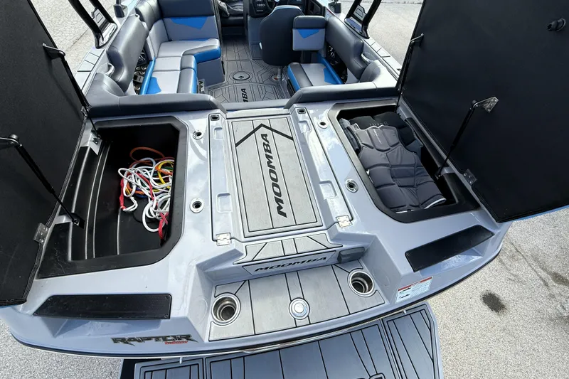 Slide: The Image of 2022 Moomba Kaiyen boat interior with open storage compartments and seating. - 9