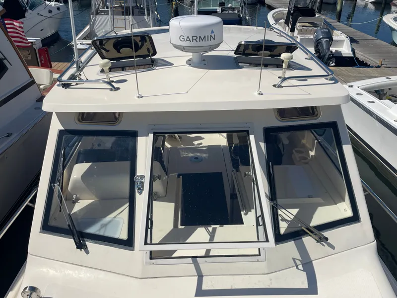 Slide: The Image of 2005 Mainship Pilot 30-II boat with Garmin equipment, docked at a marina. - 2