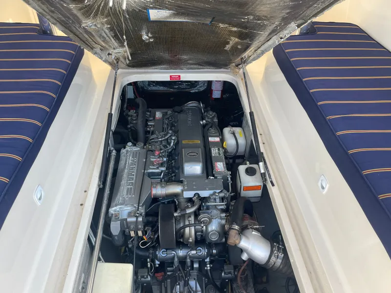 Slide: The Image of Engine compartment of a 2005 Mainship Pilot 30-II boat, showcasing the engine and seating area. - 21
