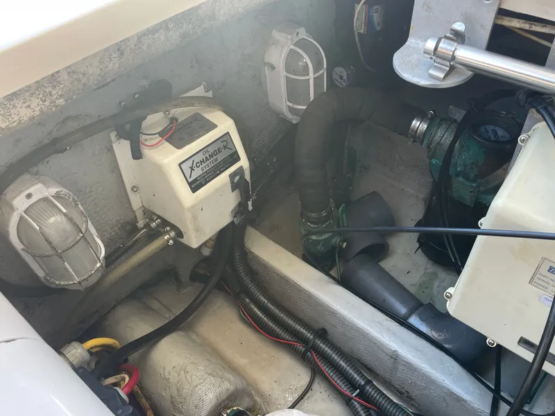 Slide: The Image of Engine compartment of a 2005 Mainship Pilot 30-II with oil change system and wiring. - 24