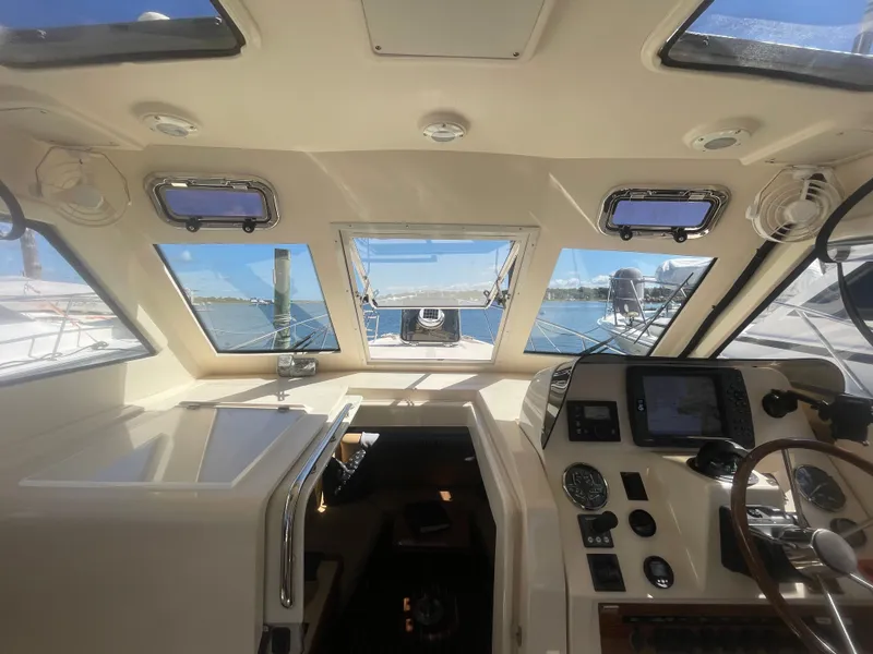 Slide: The Image of 2005 Mainship Pilot 30-II helm with navigation instruments and ocean view through windows. - 26