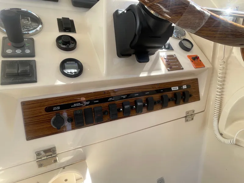 Slide: The Image of 2005 Mainship Pilot 30-II dashboard with controls and steering wheel. - 27