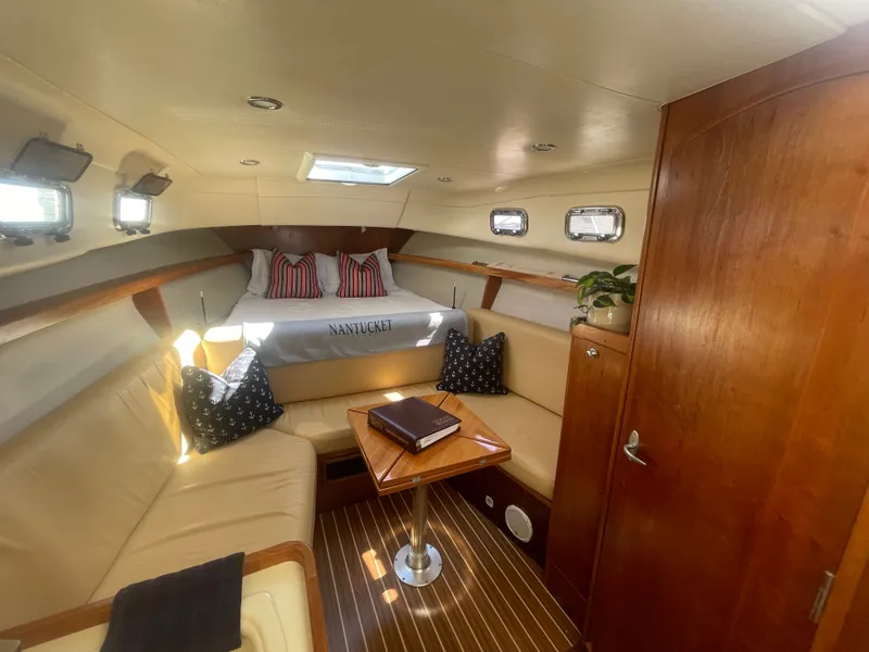 Slide: The Image of 2005 Mainship Pilot 30-II cabin interior with bed, seating, and wooden accents. - 29