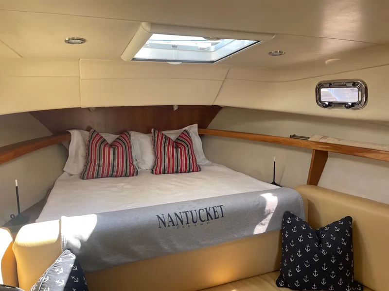 Slide: The Image of Cozy cabin interior of 2005 Mainship Pilot 30-II with skylight and nautical-themed decor. - 30