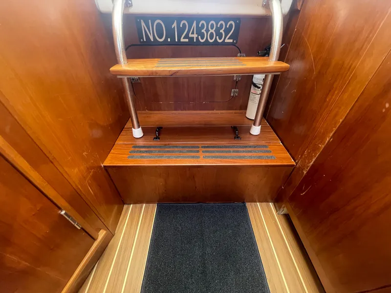 Slide: The Image of 2005 Mainship Pilot 30-II interior with wooden steps and safety features. - 32