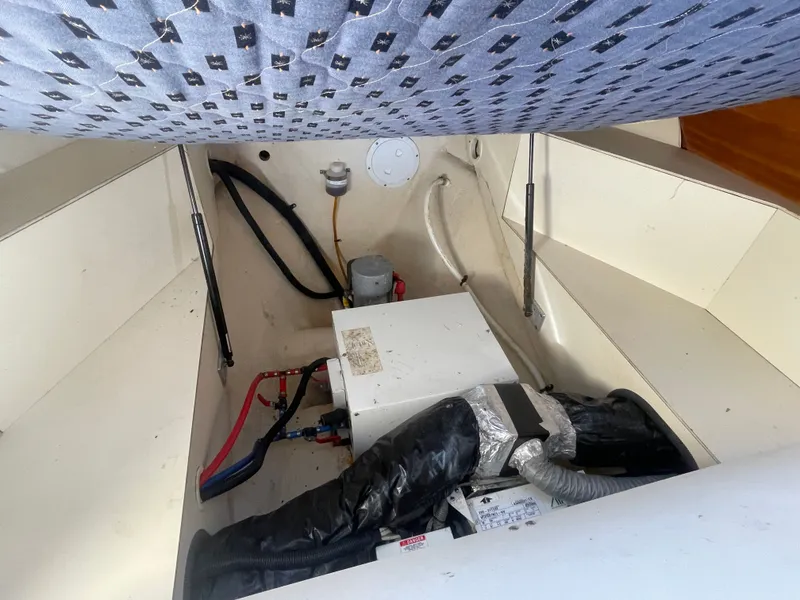 Slide: The Image of 2005 Mainship Pilot 30-II engine compartment with visible wiring and components. - 36