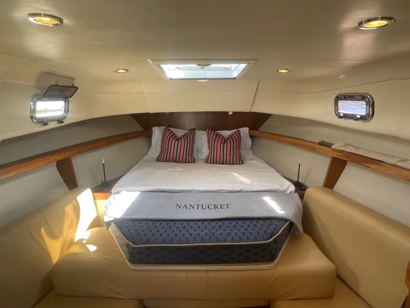 Slide: The Image of Cozy cabin interior of 2005 Mainship Pilot 30-II with bed and seating area. - 39