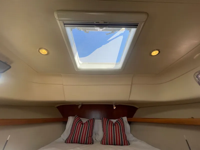 Slide: The Image of Interior cabin of 2005 Mainship Pilot 30-II with skylight and striped pillows. - 44