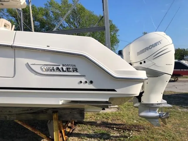 Slide: The Image of 2017 Boston Whaler 330 Outrage boat with Mercury outboard engine, side view. - 2