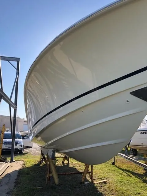 Slide: The Image of 2017 Boston Whaler 330 Outrage boat on stands, side view. - 3