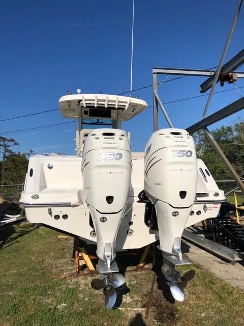 Slide: The Image of 2017 Boston Whaler 330 Outrage with twin outboard engines, docked on land. - 5