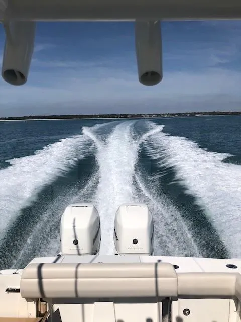 Slide: The Image of Boston Whaler 330 Outrage 2017 cruising on open water, leaving a wake behind. - 9