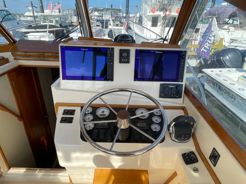 Slide: The Image of Helm of 2015 Fortier 30 boat with dual navigation screens and steering wheel. - 10