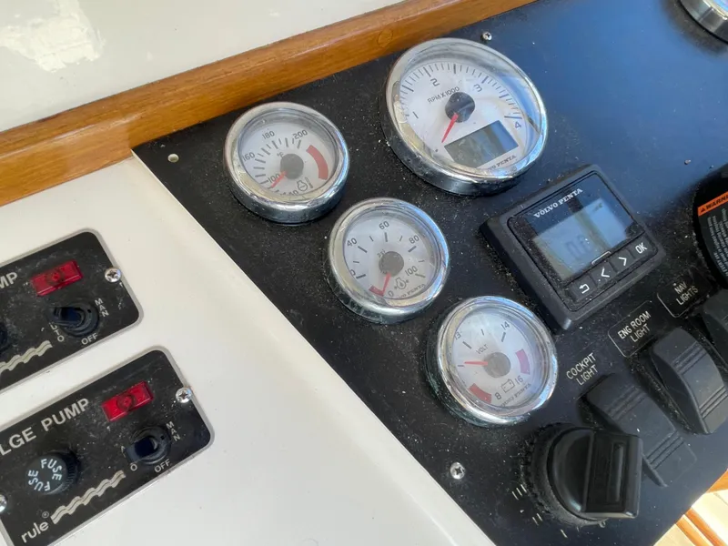 Slide: The Image of Control panel of a 2015 Fortier 30 boat with gauges and switches. - 13