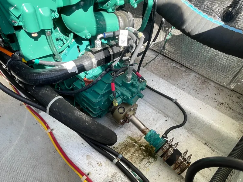 Slide: The Image of Engine compartment of a 2015 Fortier 30 boat, showcasing mechanical components and hoses. - 34