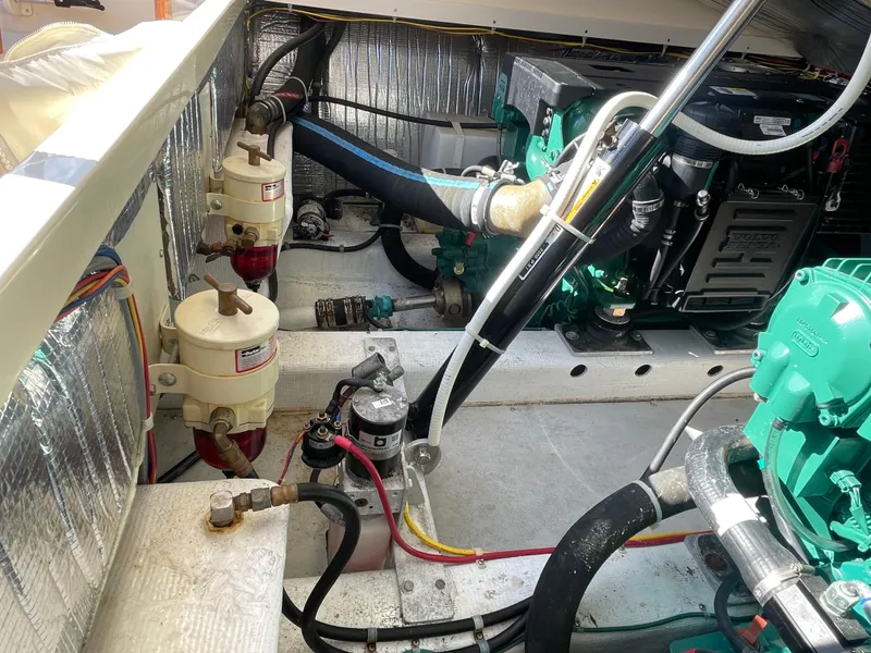 Slide: The Image of Engine compartment of a 2015 Fortier 30 boat, showcasing mechanical components and wiring. - 36