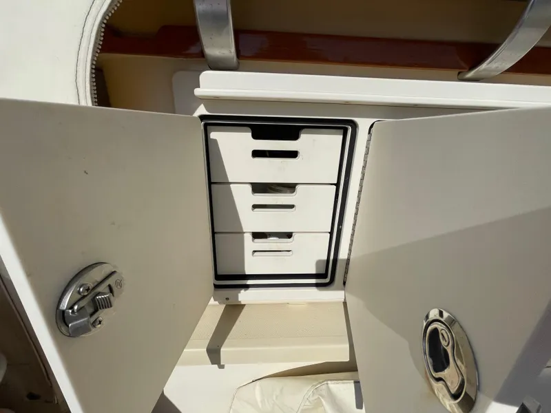 Slide: The Image of Cabinet with drawers on a 2015 Fortier 30 boat, featuring sleek white design. - 42