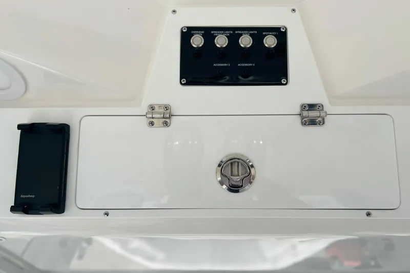 Slide: The Image of Control panel of 2026 Sea Fox 268 Commander boat with switches and storage compartment. - 12