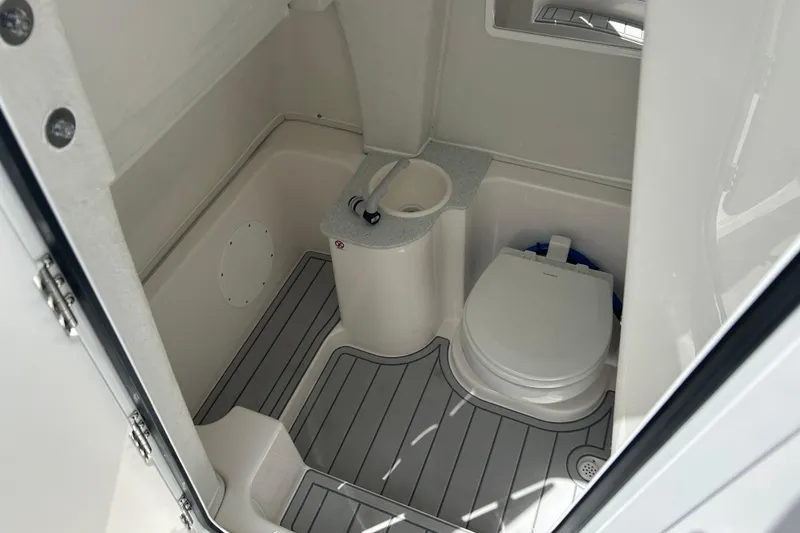 Slide: The Image of 2026 Sea Fox 268 Commander boat bathroom with toilet and sink, featuring sleek design. - 17
