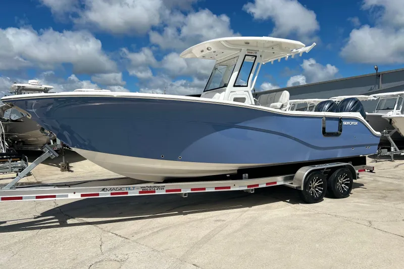 Slide: The Image of 2026 Sea Fox 268 Commander boat on trailer under blue sky. - 2