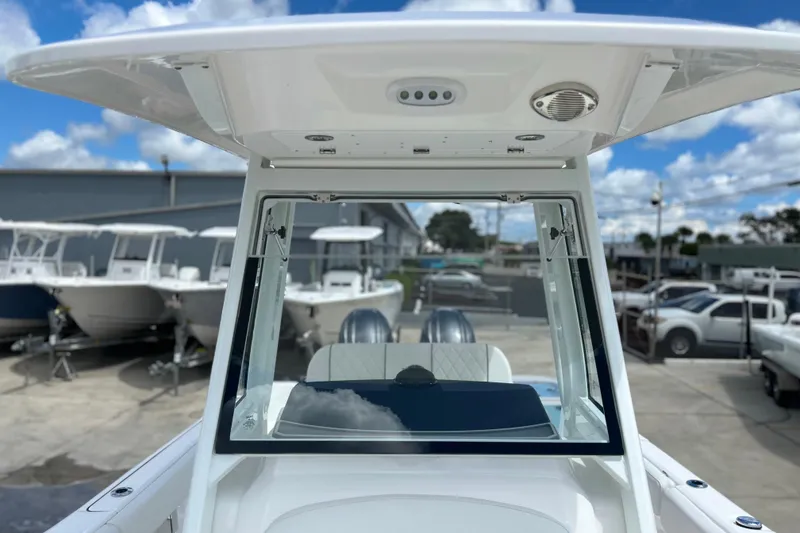 Slide: The Image of 2026 Sea Fox 268 Commander boat with T-top, docked under a blue sky. - 7