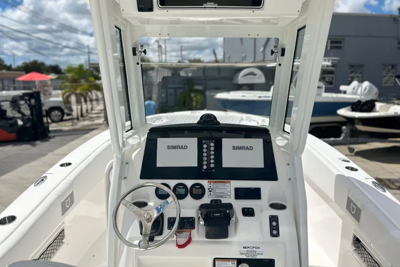Slide: The Image of 2026 Sea Fox 268 Commander boat dashboard with Simrad electronics and steering wheel. - 9