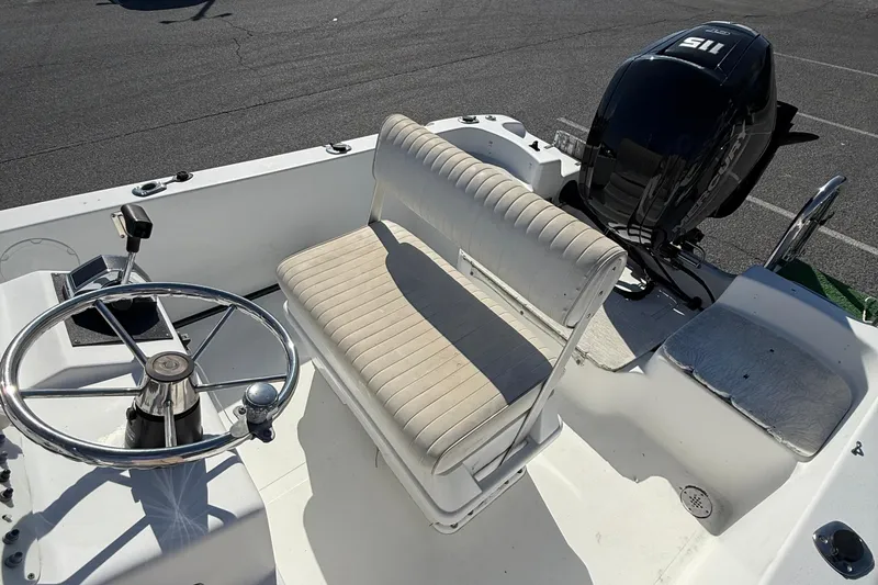 Slide: The Image of 2004 Sea Pro 190 Center Console boat interior with steering wheel and seating. - 10