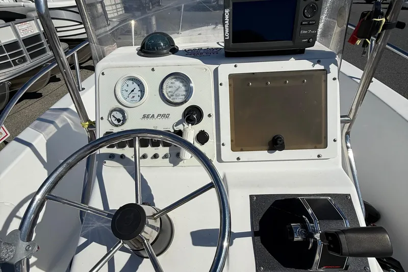 Slide: The Image of 2004 Sea Pro 190 Center Console dashboard with steering wheel and gauges. - 11