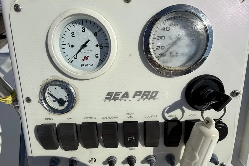 Slide: The Image of Dashboard of a 2004 Sea Pro 190 Center Console boat with gauges and switches. - 12