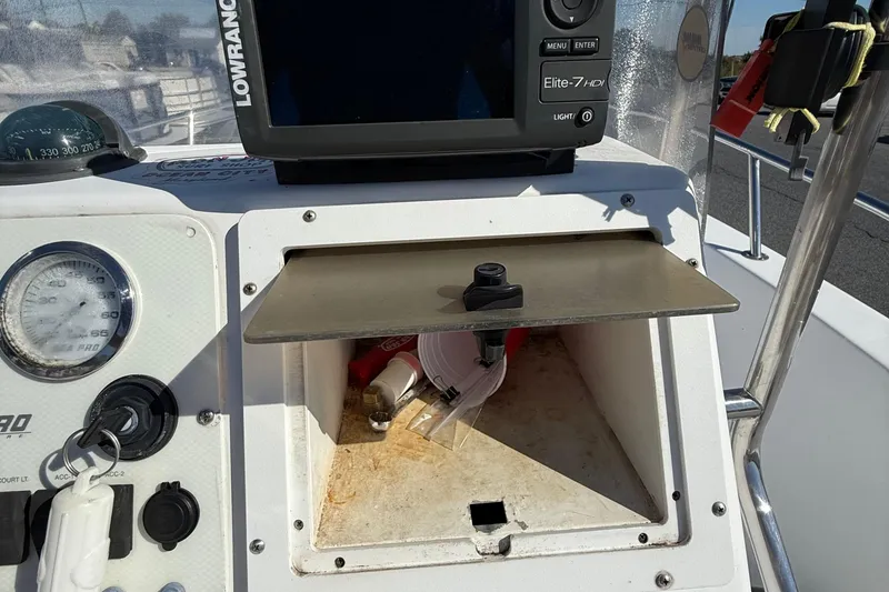Slide: The Image of 2004 Sea Pro 190 Center Console dashboard with Lowrance Elite-7 HDI and storage compartment. - 13