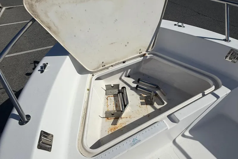 Slide: The Image of Open storage compartment on 2004 Sea Pro 190 Center Console boat, showing metal brackets inside. - 15
