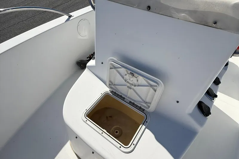 Slide: The Image of 2004 Sea Pro 190 Center Console boat with open storage compartment on deck. - 16