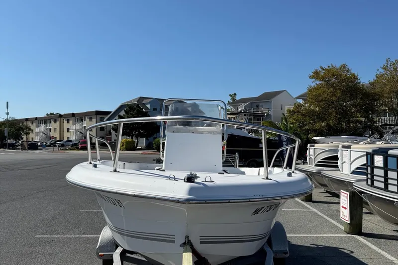 Slide: The Image of 2004 Sea Pro 190 Center Console boat parked in a marina under clear blue sky. - 3