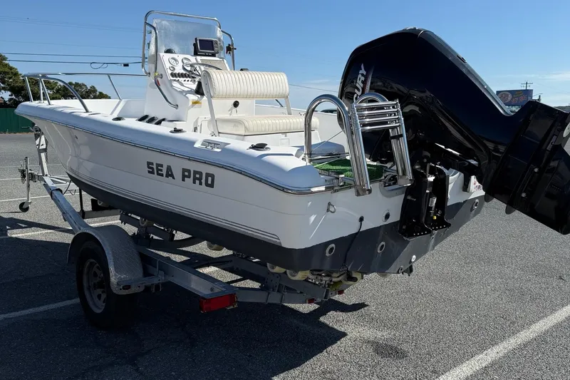 Slide: The Image of 2004 Sea Pro 190 Center Console boat on trailer, featuring a powerful outboard motor. - 6
