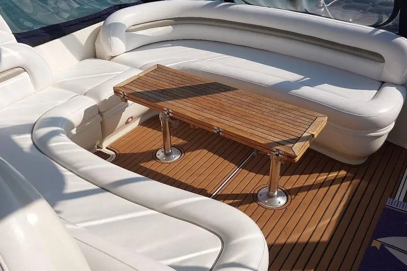 Slide: The Image of Luxurious seating area on 2004 Sea Ray 420 Sundancer yacht with wooden table. - 11