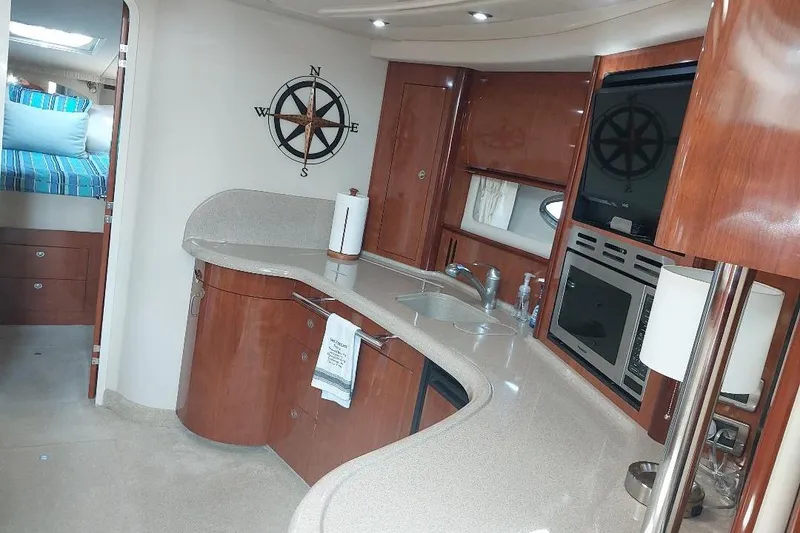 Slide: The Image of Luxurious interior of 2004 Sea Ray 420 Sundancer yacht with modern kitchen amenities. - 13