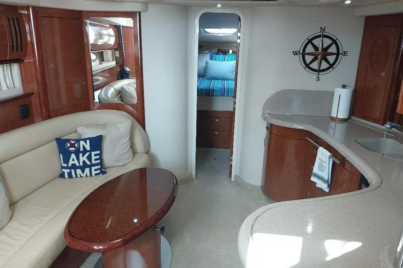 Slide: The Image of Luxurious 2004 Sea Ray 420 Sundancer interior with elegant seating and modern kitchen area. - 14