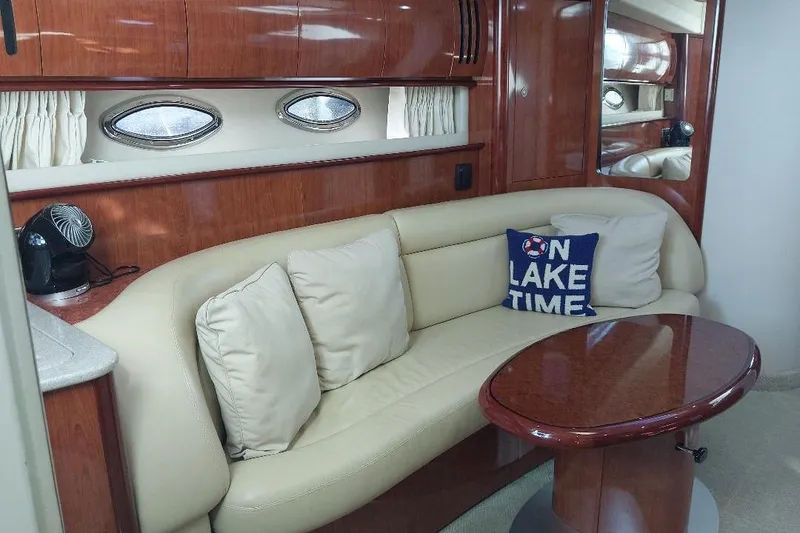 Slide: The Image of Luxurious 2004 Sea Ray 420 Sundancer interior with plush seating and elegant wood finishes. - 16