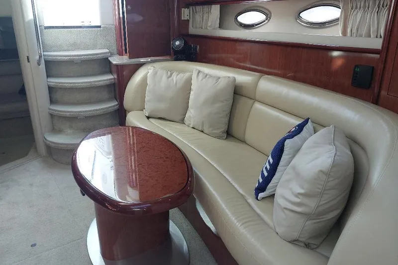 Slide: The Image of Luxurious interior of 2004 Sea Ray 420 Sundancer with plush seating and elegant table. - 17