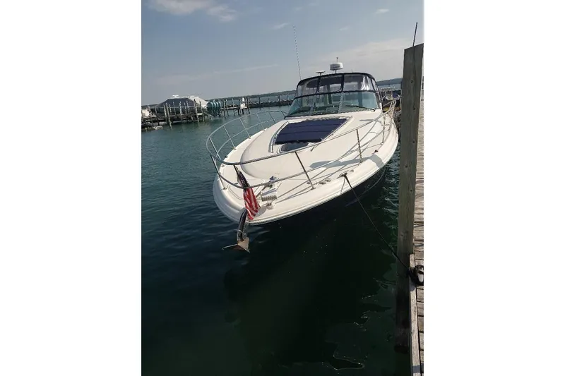 Slide: The Image of 2004 Sea Ray 420 Sundancer yacht docked at marina, clear sky, calm water. - 2